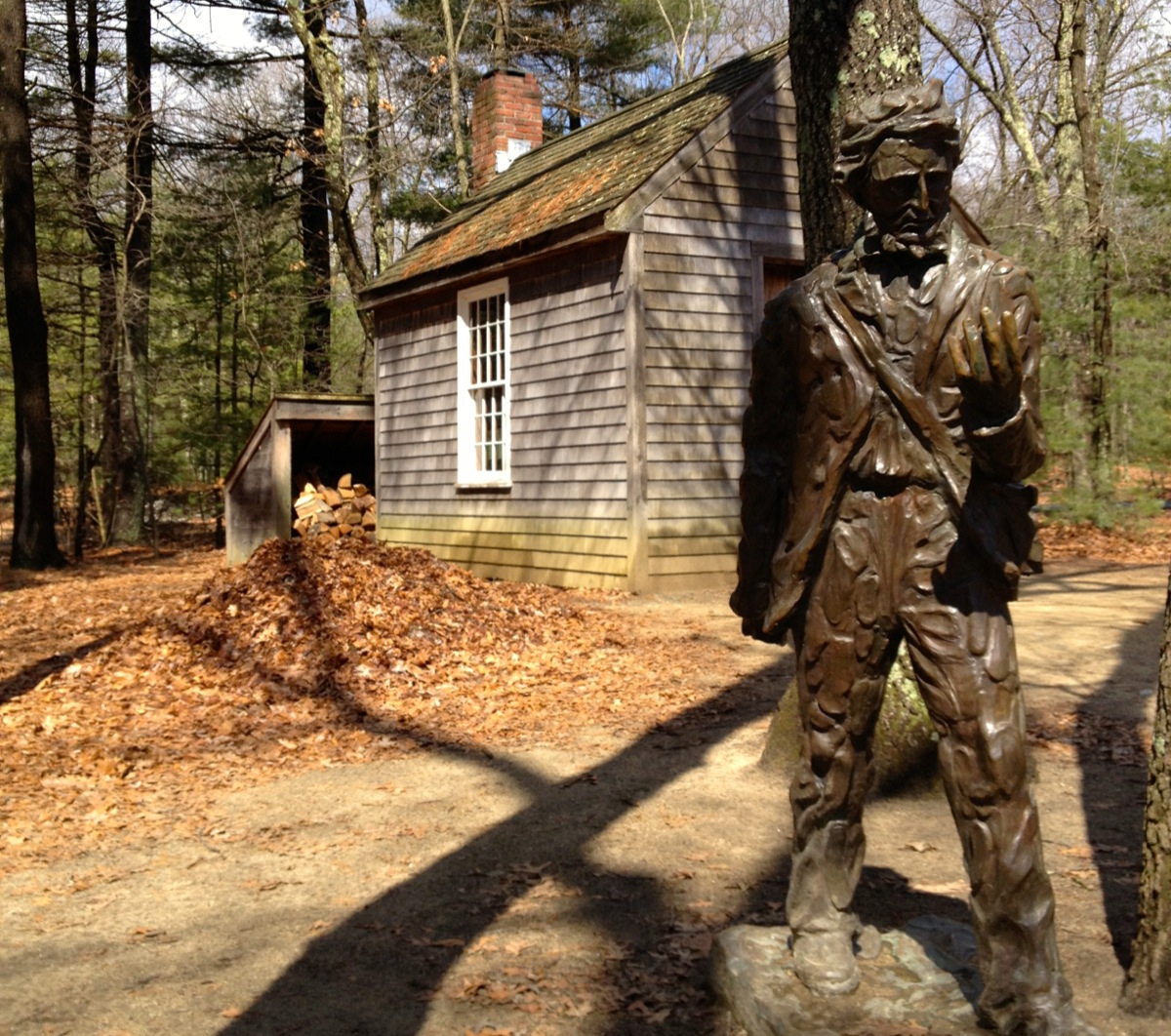 A replica of Thoreau&#039;s hut, with a statue of the man himself