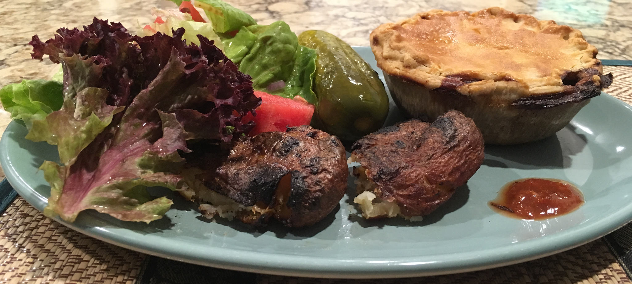 Steak and Mushroom Pie with salad and thrice-baked potatoes. The salad is non-authentically Scottish